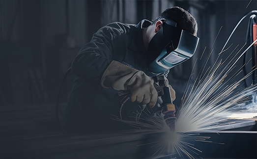 Technician operating metal cutting equipment in a fabrication shop